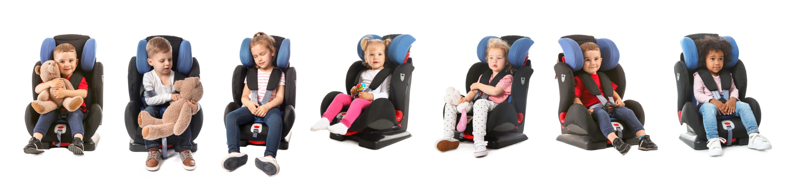 Six young children sitting in car seats. Each child is in a different seat and wearing casual clothes. The children appear to be a mix of boys and girls, with some holding stuffed animals or toys. The car seats are various models and colors with similar designs.